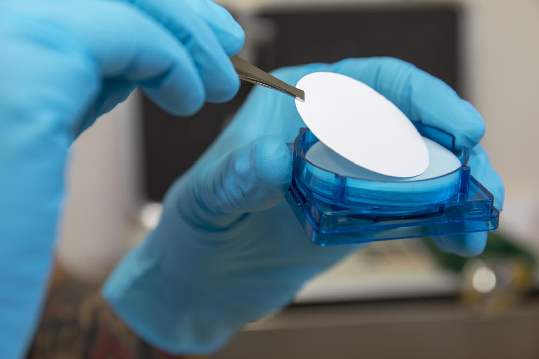 Close up shot of hands removing a filter from a mercury detector