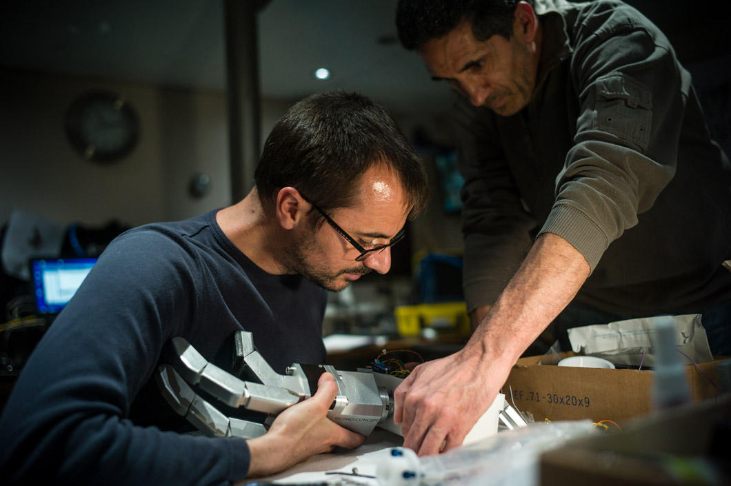 An engineer manipulates a robotic hand.