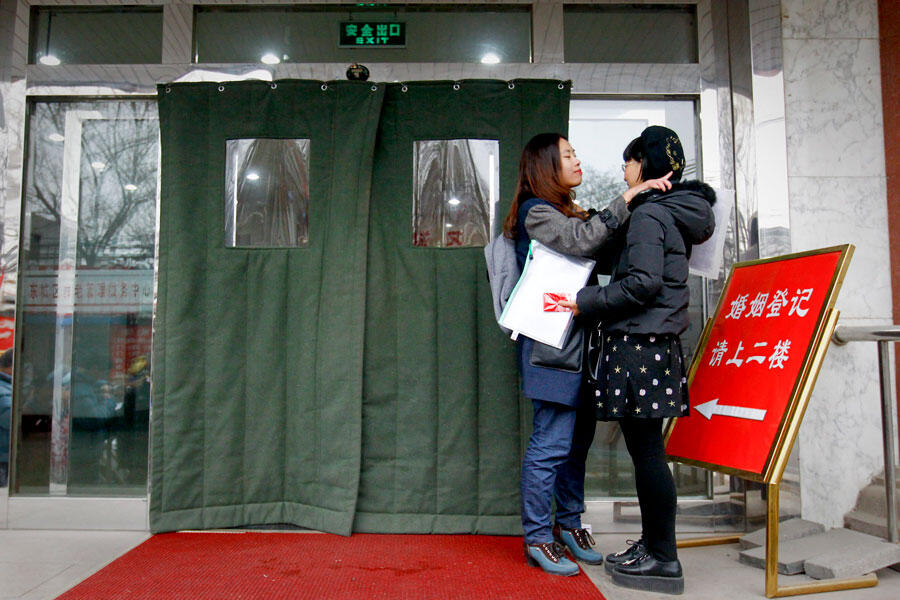 Two lovers talk by the entrance to the marriage registry office where they asked to be married, knowing that they will be denied