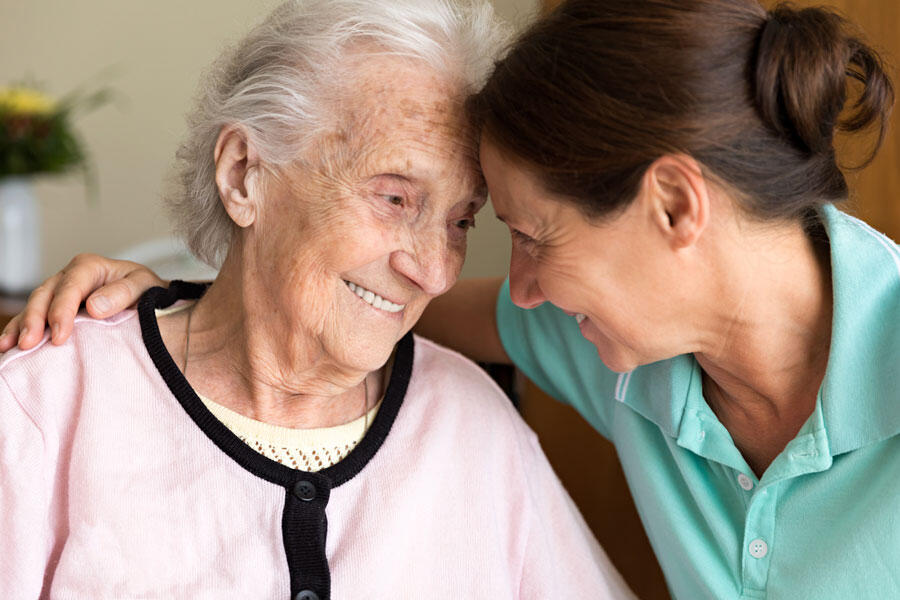 An Elderly woman and a care assistant