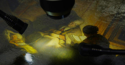 close-up shot of a painting being examined by a microscope