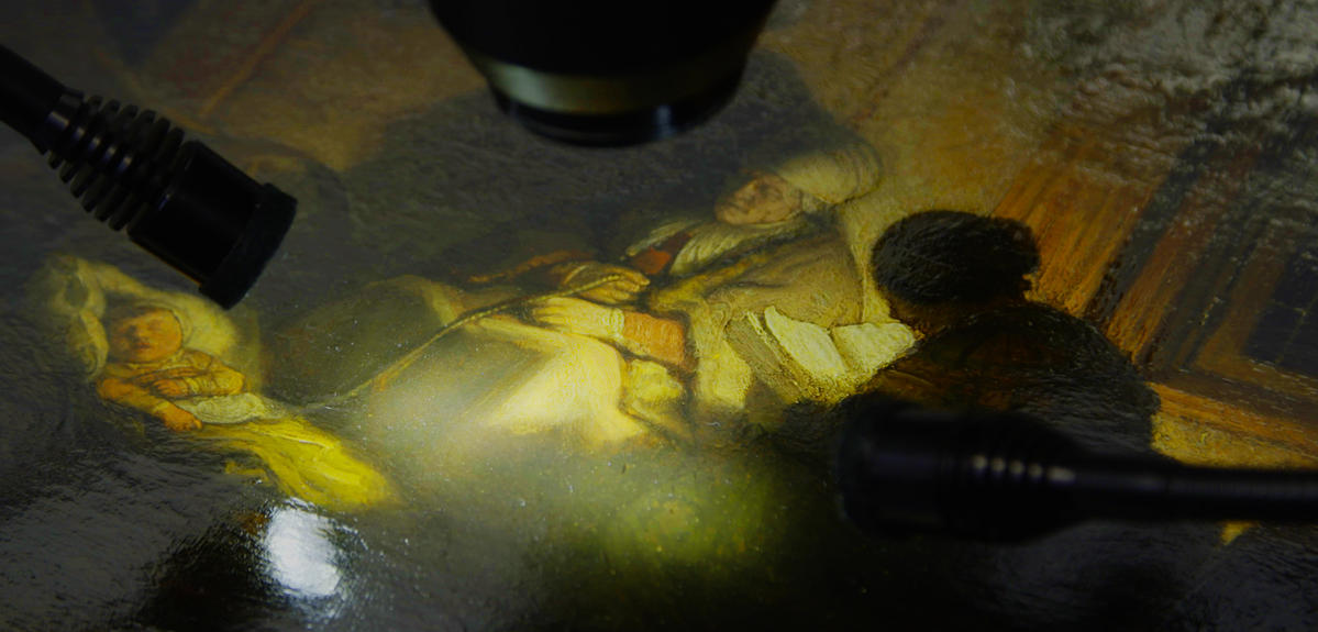 close-up shot of a painting being examined by a microscope